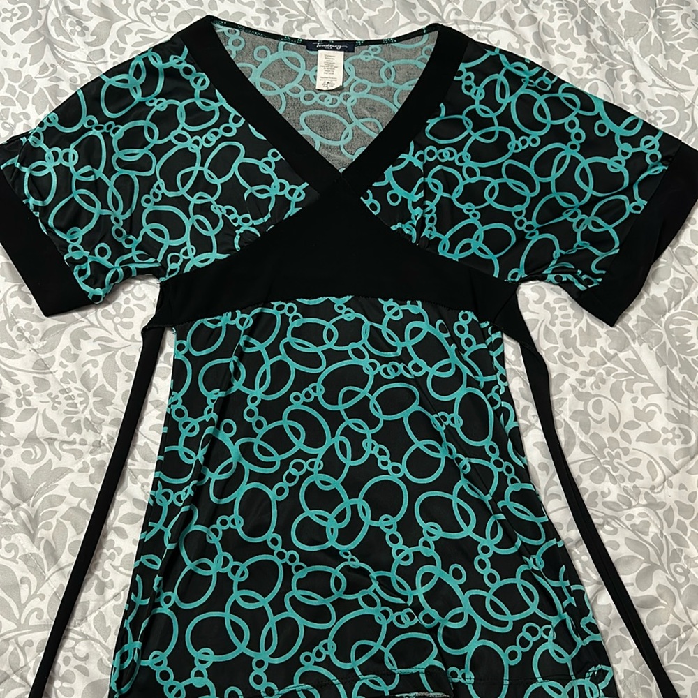 Small form-fitting and business-casual blouse that ties in the back.